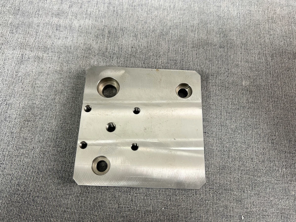 Machined rectangular mounting plate with counterbored holes and rounded corners
